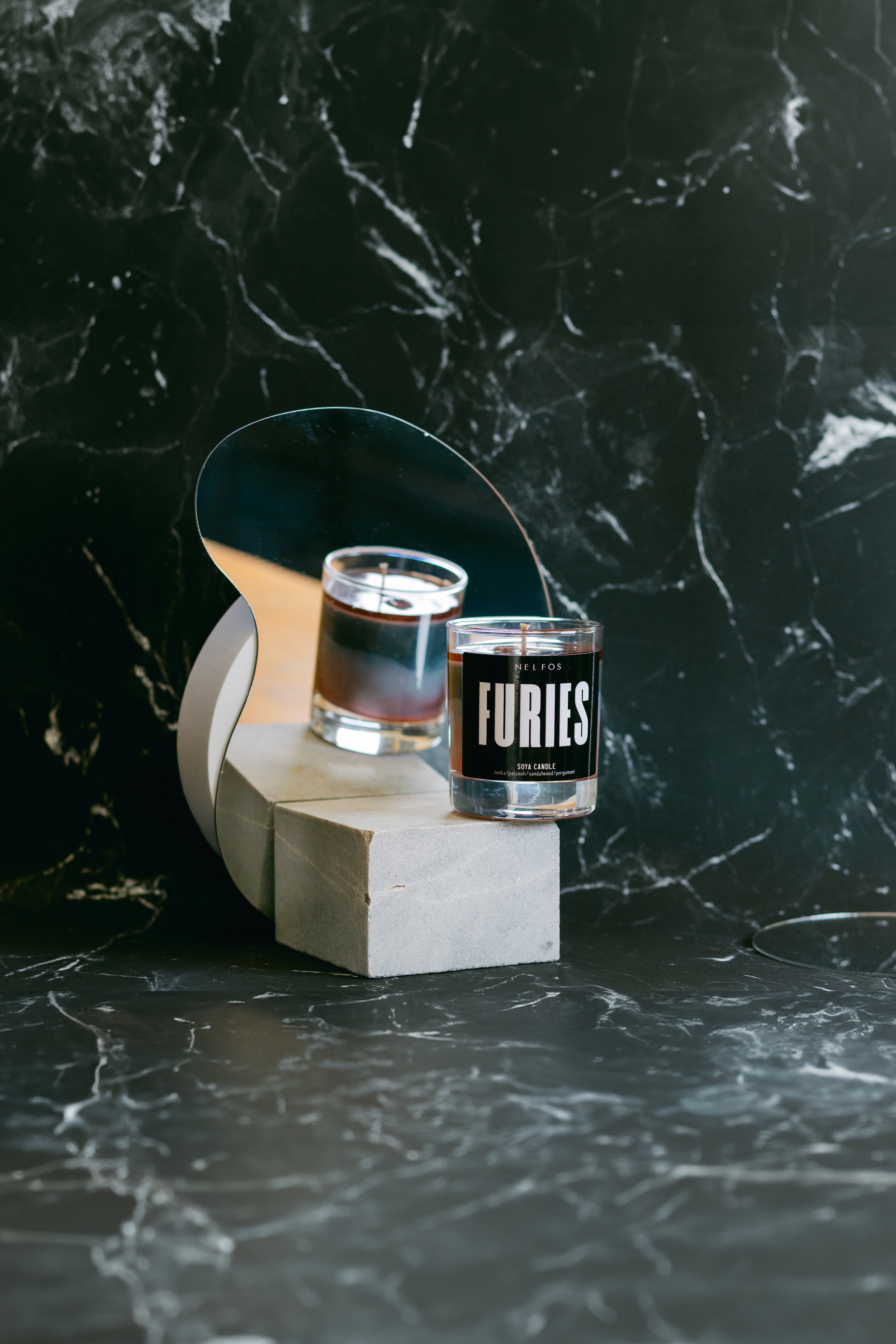 Two shot glasses with 'Furies' branding on a dark marble surface