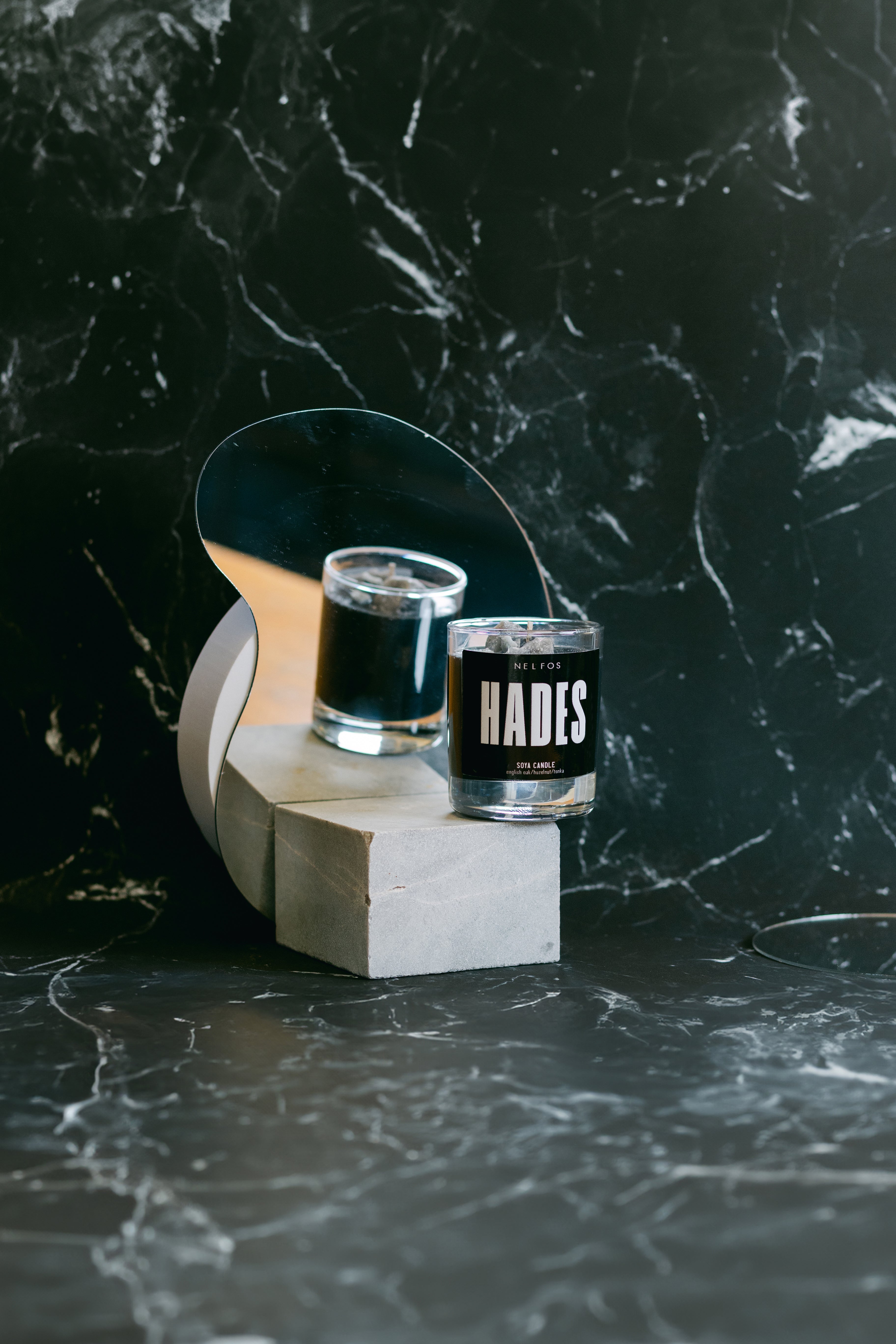 Two shot glasses with 'Hades' label on a dark marble surface