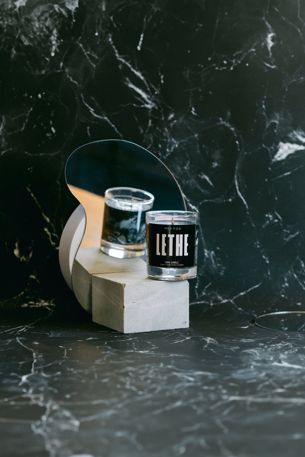 Two candles labeled 'Lethe' on a dark marble surface